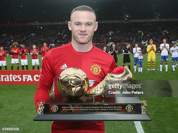 Wayne Rooney of Manchester United poses with a golden boot to mark his 250th Manchester United goal, which saw him break Charlton's club record,...
