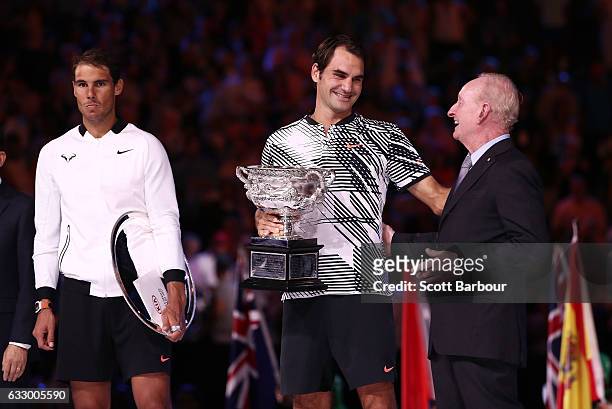 Rafael Nadal of Spain and Rod Laver look on as Roger Federer of Switzerland poses with the Norman Brookes Challenge Cup on stage after the Men's...