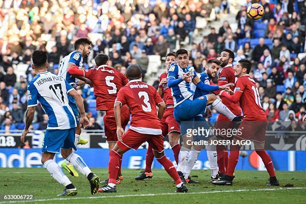 Espanyol's defender Marc Navarro heads the ball to score a goal during the Spanish league football match RCD Espanyol vs Sevilla FC at the...