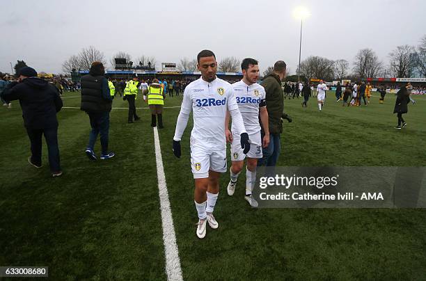Dejected Kemar Roofe and Lewis Coyle of Leeds United walk off the pitch at the end of the Emirates FA Cup Fourth Round match between Sutton United...