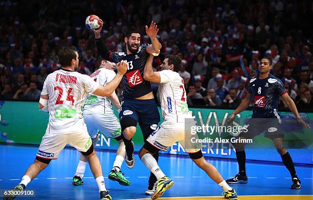 Christian O'Sullivan of Norway and Eivind Tangen of Norway tackle Nikola Karabatic of France during the 25th IHF Men's World Championship 2017 Final...