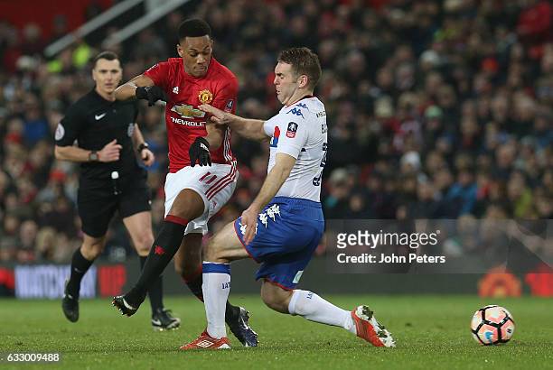 Anthony Martial of Manchester United in action with Jake Buxton of Wigan Athletic during the Emirates FA Cup Fourth Round match between Manchester...