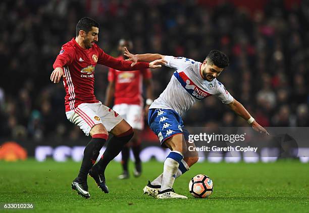 Jake Buxton of Wigan Athletic holds off Henrikh Mkhitaryan of Manchester United during the Emirates FA Cup Fourth round match between Manchester...