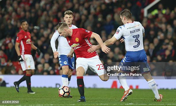 Luke Shaw of Manchester United in action with Jake Buxton of Wigan Athletic during the Emirates FA Cup Fourth Round match between Manchester United...