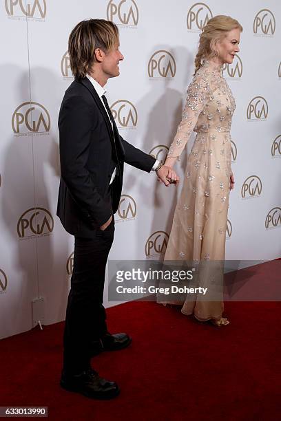 Keith Urban and Nicole Kidman hold hands at the 28th Annual Producers Guild Awards at The Beverly Hilton Hotel on January 28, 2017 in Beverly Hills,...