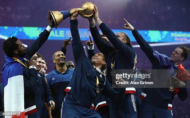 Daniel Narcisse and team mates of France lift the trophy after victory during the 25th IHF Men's World Championship 2017 Final between France and...