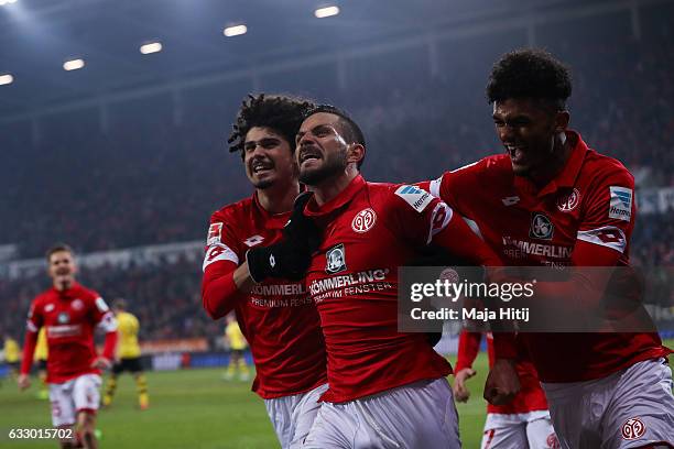 Danny Latza of Mainz celebrates with Andre Ramalho and Aaron Seydel after he scores the equalizing goal to make it 1-1 during the Bundesliga match...