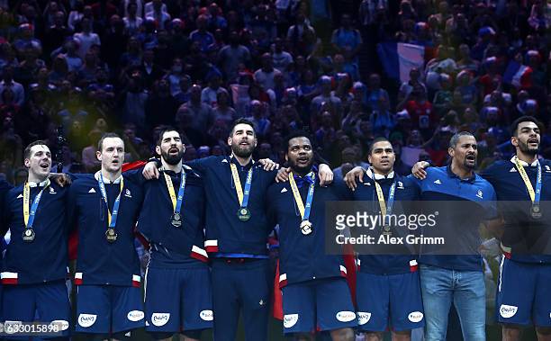 French players and coach Didier Dinart pose with their winners medals after victory during the 25th IHF Men's World Championship 2017 Final between...