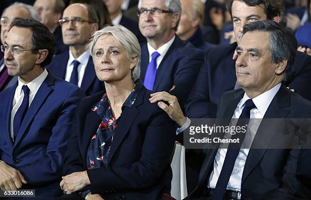 Former French prime minister and member of right-wing political party 'Les Republicains' Francois Fillon reacts as he touches his wife Penelope...