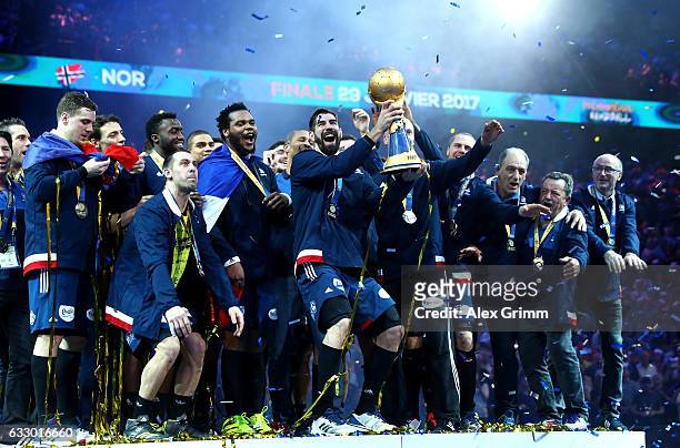 Nikola Karabatic of France celebrates victory with the trophy and team mates after the 25th IHF Men's World Championship 2017 Final between France...
