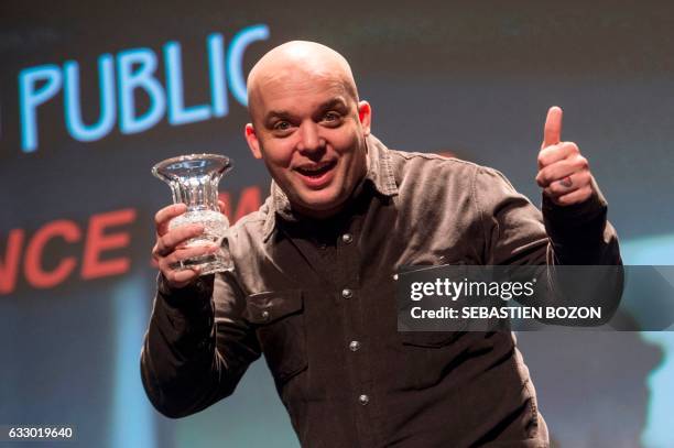 British filmmaker Colm Mccarty holds his trophy after receiving the public's award during the prize ceremony of the 24th Gerardmer fantastic film...