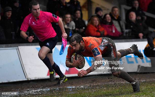 Falcons wing Belisario Agulla dives over the line to score during the Anglo- Welsh Cup match between Newport Gwent Dragons and Newcastle Falcons at...