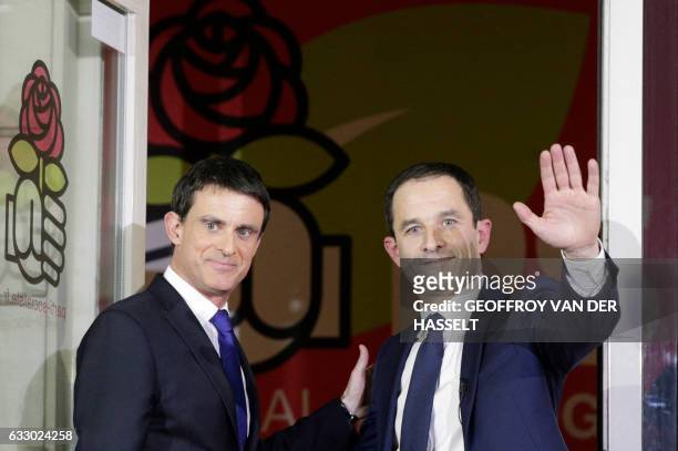 Winner of the left-wing primaries ahead of France's 2017 presidential elections Benoit Hamon gestures next to defeated candidate Manuel Valls...