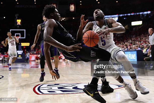 Kadeem Allen of the Arizona Wildcats collides into Noah Dickerson of the Washington Huskies as he drives to the basket during the first half of the...