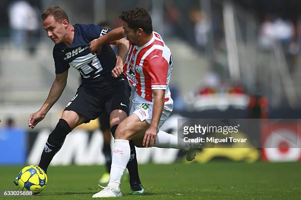 Abraham Gonzalez of Pumas fights for the ball with Luis Gallegos of Necaxa during the 4th round match between Pumas UNAM and Necaxa as part of the...