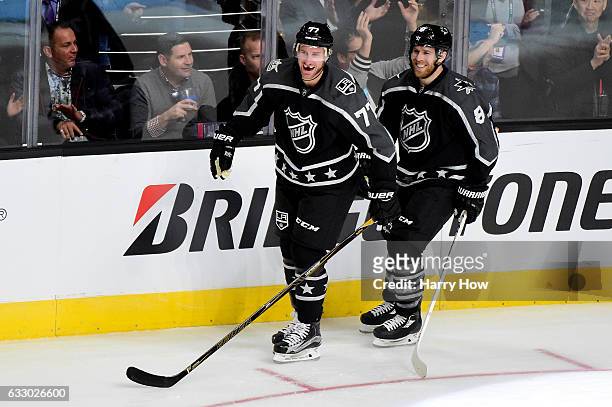 Jeff Carter of the Los Angeles Kings celebrates with Joe Pavelski of the San Jose Sharks during the 2017 Honda NHL All-Star Game Semifinal at Staples...
