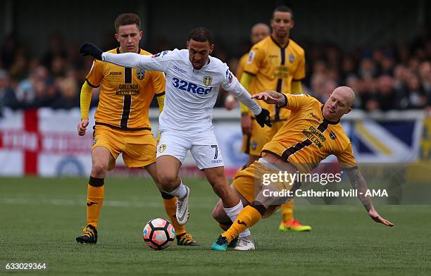 Kemar Roofe of Leeds United is tackled Nicky Bailey of Sutton United as Adam May of Sutton United looks on during the Emirates FA Cup Fourth Round...