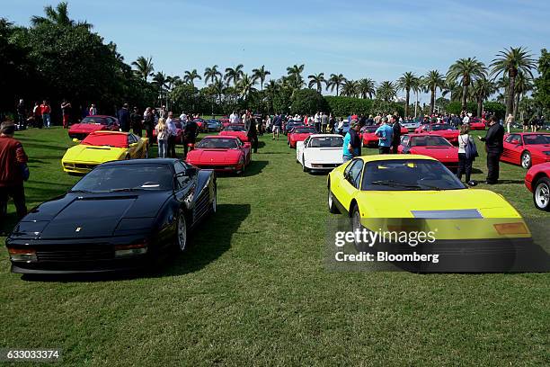 Attendees walk past Ferrari SpA vehicles on display during the 26th Annual Cavallino Classic Event at the Breakers Hotel in Palm Beach, Florida,...