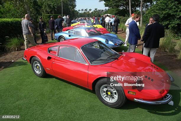 Attendees walk past Ferrari SpA vehicles on display during the 26th Annual Cavallino Classic Event at the Breakers Hotel in Palm Beach, Florida,...