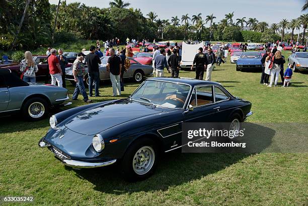 Attendees walk past Ferrari SpA vehicles on display during the 26th Annual Cavallino Classic Event at the Breakers Hotel in Palm Beach, Florida,...