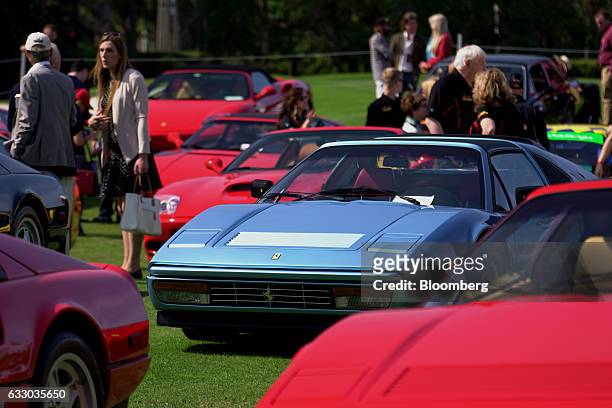Attendees walk past Ferrari SpA vehicles on display during the 26th Annual Cavallino Classic Event at the Breakers Hotel in Palm Beach, Florida,...