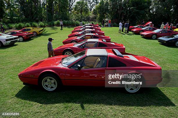 Young attendee walks past a display of 1980's Ferrari 328 GTS sports vehicles during the 26th Annual Cavallino Classic Event at the Breakers Hotel in...