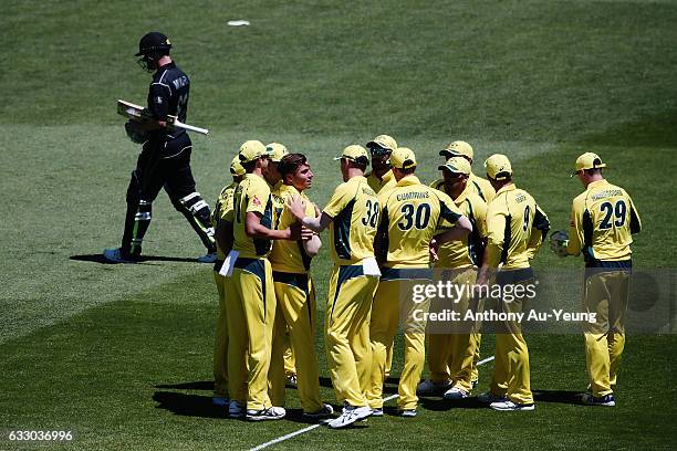 Marcus Stoinis of Australia celebrates with teammates for the wicket of Colin Munro of New Zealand during the first One Day International game...