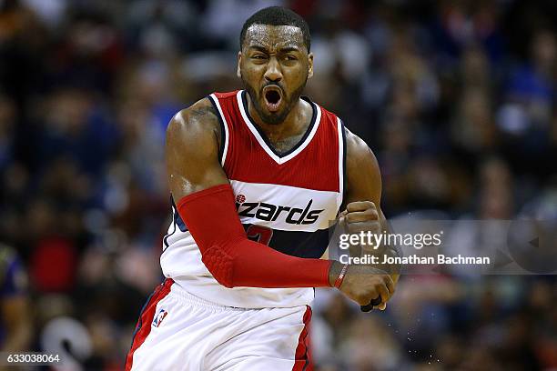 John Wall of the Washington Wizards reacts after scoring during the first half of a game against the New Orleans Pelicans at the Smoothie King Center...