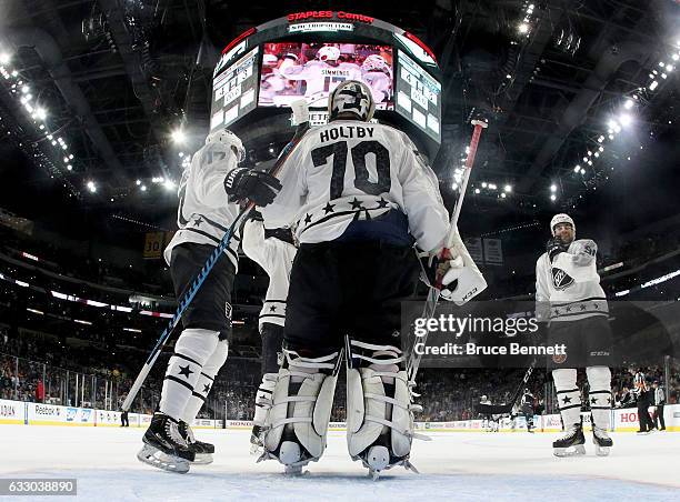 Wayne Simmonds of the Philadelphia Flyers celebrates with Braden Holtby of the Washington Capitals after the Metropolitan Division All-Stars defeated...