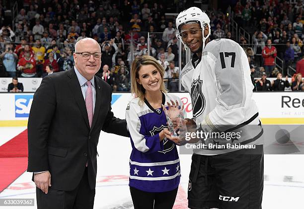 Deputy NHL Commissioner Bill Daly and anthem singer Courtney Daniels present Wayne Simmonds of the Philadelphia Flyers with the 2017 Honda NHL...