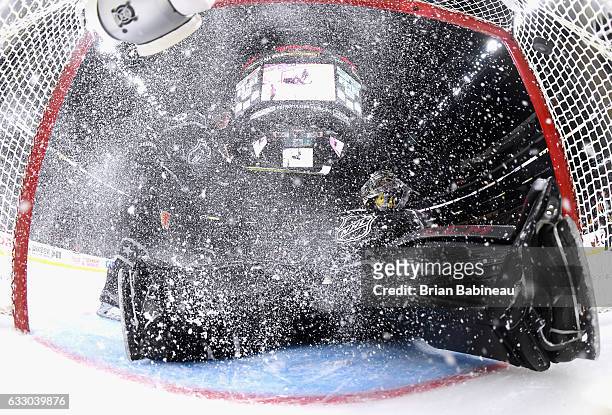 Johnny Gaudreau of the Calgary Flames and Mike Smith of the Arizona Coyotes can't stop the puck going into the net on a second shot on goal by Cam...