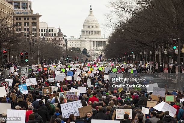 Demonstrators march down Pennsylvania Avenue during a protest on January 29, 2017 in Washington, DC. Protestors in Washington and around the country...