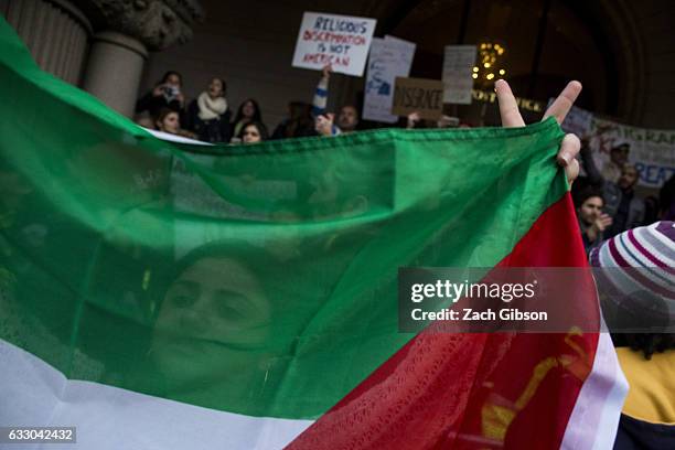 Demonstrators gather near the steps of the Trump Hotel International during a protest on January 29, 2017 in Washington, DC. Protestors in Washington...