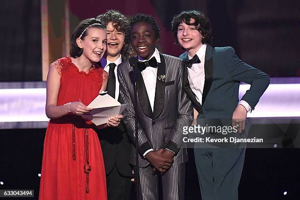 Actors Millie Bobby Brown, Gaten Matarazzo, Caleb McLaughlin, and Finn Wolfhard speak onstage during the 23rd Annual Screen Actors Guild Awards at...