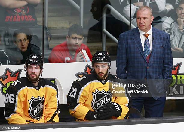 Nikita Kucherov of the Tampa Bay Lightning, Vincent Trocheck of the Florida Panthers and Coach Michel Therrien look on from the bench area during the...