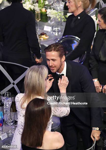 Actor Ryan Gosling has his tie adjusted by Meryl Streep during The 23rd Annual Screen Actors Guild Awards at The Shrine Auditorium on January 29,...