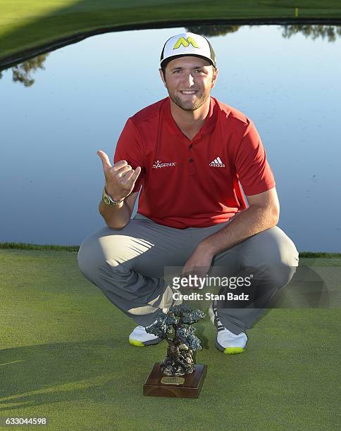 Jon Rahm of Spain poses with his trophy on the 18th hole during the final round of the Farmers Insurance Open at Torrey Pines South Golf Course on...
