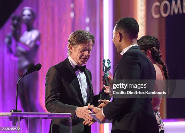 Actor William H. Macy accepts Outstanding Performance by a Male Actor in a Comedy Series for 'Shameless' from recording artist John Legend and actor...