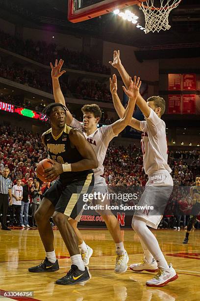 Purdue Boilermakers forward Caleb Swanigan is closely guarded by Nebraska Cornhuskers forward Michael Jacobson and Nebraska Cornhuskers forward Jack...