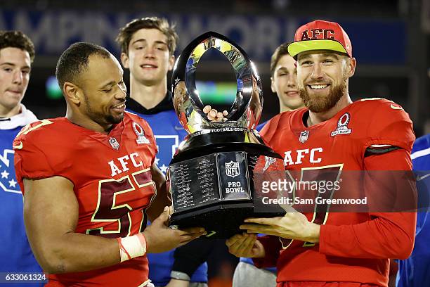 Lorenzo Alexander and Travis Kelce pose with the tophy after the AFC defeated the NFC 20 to 13 during the NFL Pro Bowl at the Orlando Citrus Bowl on...