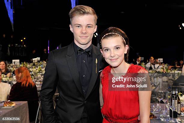 Actors Nicholas Hamilton and Millie Bobby Brown attend The 23rd Annual Screen Actors Guild Awards Cocktail Reception at The Shrine Auditorium on...