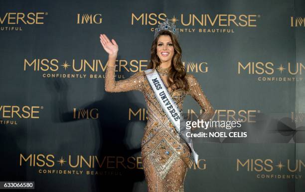 The new Miss Universe Iris Mittenaere of France waves to photographers during a press conference after being crowned the winner at the Miss Universe...