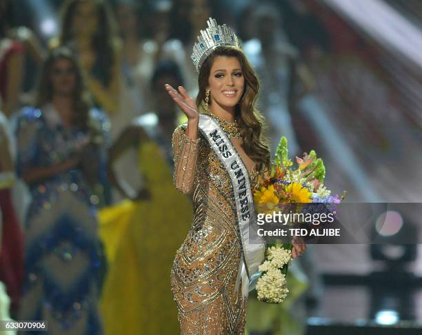 Miss Universe candidate Iris Mittenaere of France waves to the audience after winning the title in the Miss Universe pageant at the Mall of Asia...