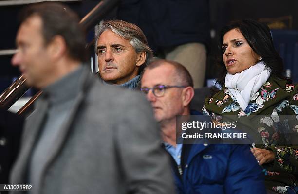 Former head coach Roberto Mancini and his wife Silvia Fortini attend the French L1 football match between Paris Saint-Germain and Monaco at the Parc...