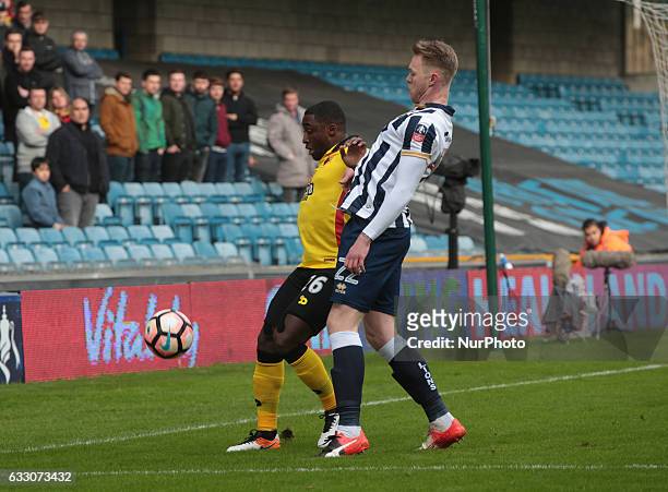 Watford's Brice Dja Djedje and Millwall's Steve Morison during The Emirates FA Cup - Fourth Round match between Millwall against Watford at The Den...