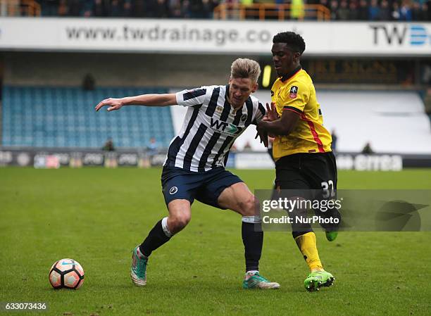 Millwall's Steve Morison holds of Watford's Brandon Mason during The Emirates FA Cup - Fourth Round match between Millwall against Watford at The Den...