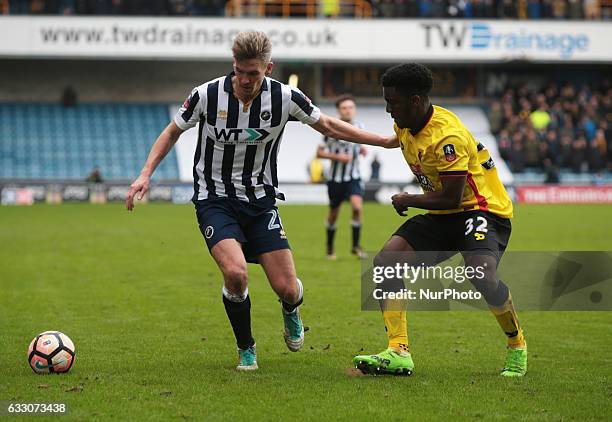 Millwall's Steve Morison holds of Watford's Brandon Mason during The Emirates FA Cup - Fourth Round match between Millwall against Watford at The Den...