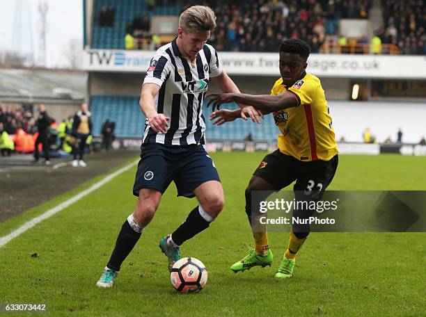 Millwall's Steve Morison holds of Watford's Brandon Mason during The Emirates FA Cup - Fourth Round match between Millwall against Watford at The Den...