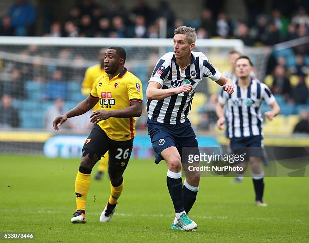 Watford's Brice Dja Djedje and Millwall's Steve Morison during The Emirates FA Cup - Fourth Round match between Millwall against Watford at The Den...