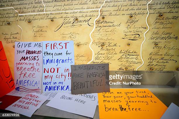 Protest signs are posted at a copy of the Constitution at a January 29th, 2017 Immigration Ban Protest at Philadelphia International Airport, in...